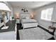 Cozy main bedroom with a large bed, neutral colors, and dark hardwood floors, plus a gray rug at 1939 Crystal Bay E Dr, Plainfield, IN 46168