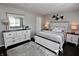 Stylish main bedroom featuring a bed, bedside tables, neutral colors, and dark hardwood floors at 1939 Crystal Bay E Dr, Plainfield, IN 46168