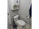 Bright bathroom with a standard height toilet, and a cabinet mounted above, plus a tissue holder at 1939 Crystal Bay E Dr, Plainfield, IN 46168