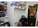 Organized walk-in closet featuring shelves, rods, and some luggage, with views of the bedroom in the back at 1939 Crystal Bay E Dr, Plainfield, IN 46168