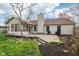 Backyard with a patio, landscaping and a sunroom addition to the house at 2020 Cross Willow Ln, Indianapolis, IN 46239