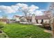 Well-maintained backyard with lawn, mature trees, and sunroom at 2020 Cross Willow Ln, Indianapolis, IN 46239