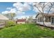 Spacious backyard with green lawn, mature trees, shed, and fenced perimeter at 2020 Cross Willow Ln, Indianapolis, IN 46239