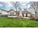 Landscaped backyard featuring a sunroom and a lawn at 2020 Cross Willow Ln, Indianapolis, IN 46239