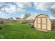 Large, fenced backyard featuring a storage shed and well-maintained lawn at 2020 Cross Willow Ln, Indianapolis, IN 46239