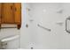 Accessible shower stall, safety bar, corner shelves, clean white tile and light wood cabinet at 2020 Cross Willow Ln, Indianapolis, IN 46239