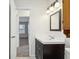 Stylish bathroom featuring a vanity and mirror, next to door and bedroom beyond at 2020 Cross Willow Ln, Indianapolis, IN 46239