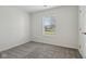 Bedroom showcasing a window and neutral carpet, freshly painted white walls at 2020 Cross Willow Ln, Indianapolis, IN 46239