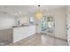 Bright dining area with access to a sunroom and view into the living room at 2020 Cross Willow Ln, Indianapolis, IN 46239