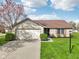 Charming home with a brick and siding exterior, attached garage, and manicured lawn at 2020 Cross Willow Ln, Indianapolis, IN 46239