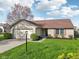 Inviting home featuring a well-kept lawn, attached garage, and lovely landscaping at 2020 Cross Willow Ln, Indianapolis, IN 46239