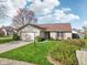 Well-maintained home featuring a brick accent, two-car garage, and a beautiful front lawn at 2020 Cross Willow Ln, Indianapolis, IN 46239