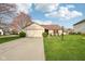 Traditional home with a well-maintained lawn, long driveway, and attached garage, offering curb appeal and convenience at 2020 Cross Willow Ln, Indianapolis, IN 46239