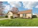Well-kept home featuring an attached garage, brick accents, and neatly landscaped front yard in a residential neighborhood at 2020 Cross Willow Ln, Indianapolis, IN 46239