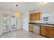 Bright kitchen with stainless steel dishwasher and access to sunroom and backyard at 2020 Cross Willow Ln, Indianapolis, IN 46239