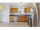 Well-lit kitchen with stainless steel appliances, tile flooring, and wood cabinetry at 2020 Cross Willow Ln, Indianapolis, IN 46239