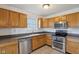 Clean kitchen with stainless steel appliances, tile flooring, and wooden cabinets at 2020 Cross Willow Ln, Indianapolis, IN 46239