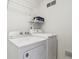 Bright laundry room features a new washer and dryer, with storage shelving and ventilation at 2020 Cross Willow Ln, Indianapolis, IN 46239