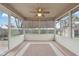 Enclosed sunroom with ceiling fan, many windows, and sliding glass door offer natural light and backyard views at 2020 Cross Willow Ln, Indianapolis, IN 46239