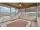 Enclosed sunroom with a ceiling fan offers natural light and backyard views at 2020 Cross Willow Ln, Indianapolis, IN 46239