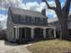 Charming two-story home with a welcoming front porch, dark shutters and a beautifully maintained lawn at 207 Blue Ridge Rd, Indianapolis, IN 46208