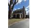 Charming two-story home featuring dark shutters, a inviting front porch and a well-manicured lawn at 207 Blue Ridge Rd, Indianapolis, IN 46208
