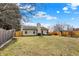 Large backyard with a wooden fence, patio, and plenty of open space at 2130 Crossford Way, Indianapolis, IN 46234
