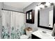 Well-lit bathroom with a shower-tub combo and stylish vanity at 2130 Crossford Way, Indianapolis, IN 46234