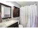 Clean bathroom featuring a well-lit mirror, cabinet, and shower at 2130 Crossford Way, Indianapolis, IN 46234