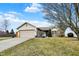 Inviting single-story home with an attached garage, landscaped yard, and a walkway leading to the front door at 2130 Crossford Way, Indianapolis, IN 46234