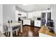 Well-lit kitchen with white cabinetry, stainless steel appliances, adjacent dining area, and hardwood floors at 2130 Crossford Way, Indianapolis, IN 46234