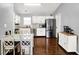 Well-appointed kitchen with white cabinets, stainless steel appliances, modern fixtures, and hardwood floors at 2130 Crossford Way, Indianapolis, IN 46234