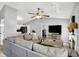 Inviting living room with a comfortable sectional sofa, fireplace, and seamless flow into the modern kitchen at 2130 Crossford Way, Indianapolis, IN 46234