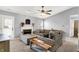 Comfortable living room with fireplace, plush sectional sofa, neutral walls, and plenty of natural light at 2130 Crossford Way, Indianapolis, IN 46234