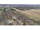 An aerial view of a charming neighborhood near farmland, with several houses and mature trees at 2165 Plantation Ln, Martinsville, IN 46151