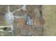 An aerial view of the house with a driveway, surrounding trees, and a mix of lawn and grassy fields at 2165 Plantation Ln, Martinsville, IN 46151