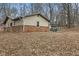 Exterior view of a single story home showcasing the brick and siding, backyard, and treed boundary at 2165 Plantation Ln, Martinsville, IN 46151