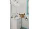 Bright bathroom with a single sink vanity, medicine cabinet, and a window with teal trim at 2165 Plantation Ln, Martinsville, IN 46151