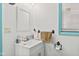 Bright bathroom with a single sink vanity, medicine cabinet, and a window with teal trim at 2165 Plantation Ln, Martinsville, IN 46151