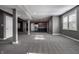 Open basement area featuring gray carpet, open floor plan, and kitchen area in the background at 2274 Finchley Rd, Carmel, IN 46032