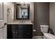 Bathroom featuring a dark vanity and a toilet at 2274 Finchley Rd, Carmel, IN 46032