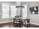 Bright dining room featuring a modern chandelier, large windows, and comfortable seating, perfect for Gathering gatherings at 2274 Finchley Rd, Carmel, IN 46032