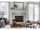 Detailed view of the living room's fireplace with granite surround, decorative mantel, and French doors at 2274 Finchley Rd, Carmel, IN 46032