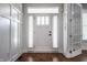 Bright foyer featuring white trim and wainscoting, gleaming hardwood floors, and elegant front door with sidelights at 2274 Finchley Rd, Carmel, IN 46032