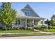Inviting home with a covered porch, well-manicured lawn, and mature landscaping at 2274 Finchley Rd, Carmel, IN 46032