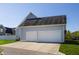 Detached two-car garage featuring white doors, a driveway, and well-manicured landscaping at 2274 Finchley Rd, Carmel, IN 46032