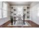 Stylish home office featuring custom built-in bookshelves, wainscoting, natural light, and a decorative rug at 2274 Finchley Rd, Carmel, IN 46032