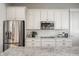 Bright kitchen featuring stainless steel appliances, white cabinetry, subway tile backsplash, and a granite countertop island at 2274 Finchley Rd, Carmel, IN 46032
