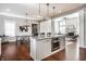 Open floor plan showcasing a kitchen island, dining area, and living room with fireplace, ideal for entertaining at 2274 Finchley Rd, Carmel, IN 46032