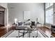 Comfortable living room with gray sofa, tiered glass coffee tables, hardwood floors, and modern decor at 2274 Finchley Rd, Carmel, IN 46032